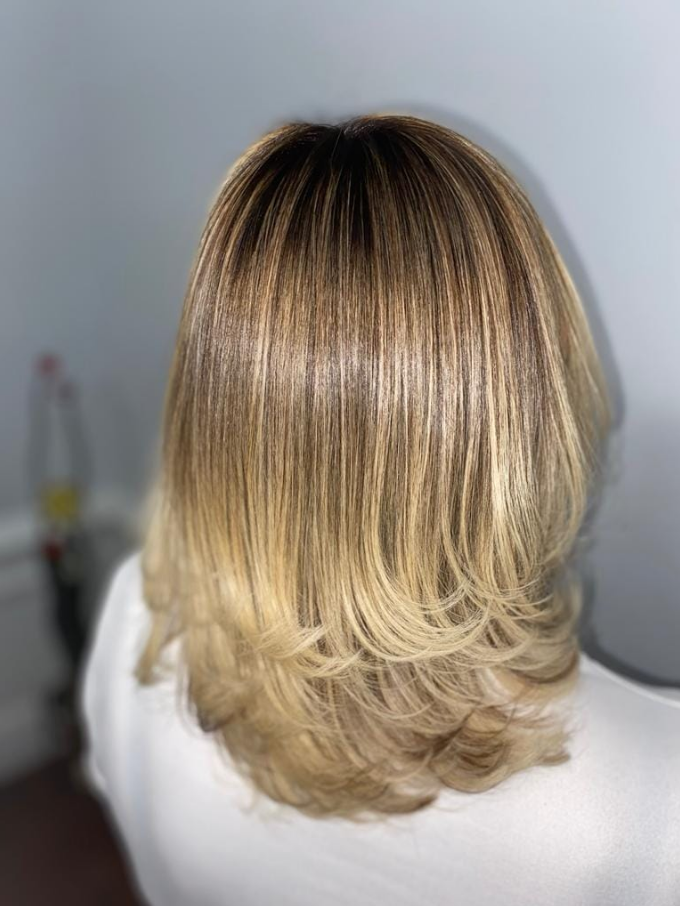 Client hair after treatment by Triny - polished layered blonde with professional styling