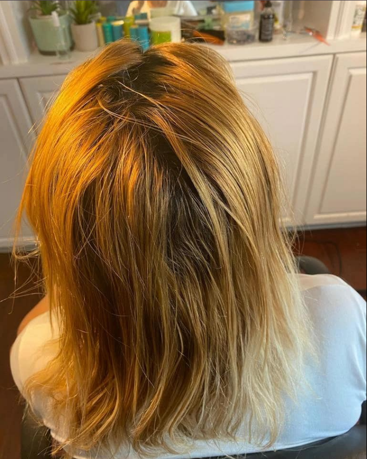 Client hair before treatment - uneven color with visible damage